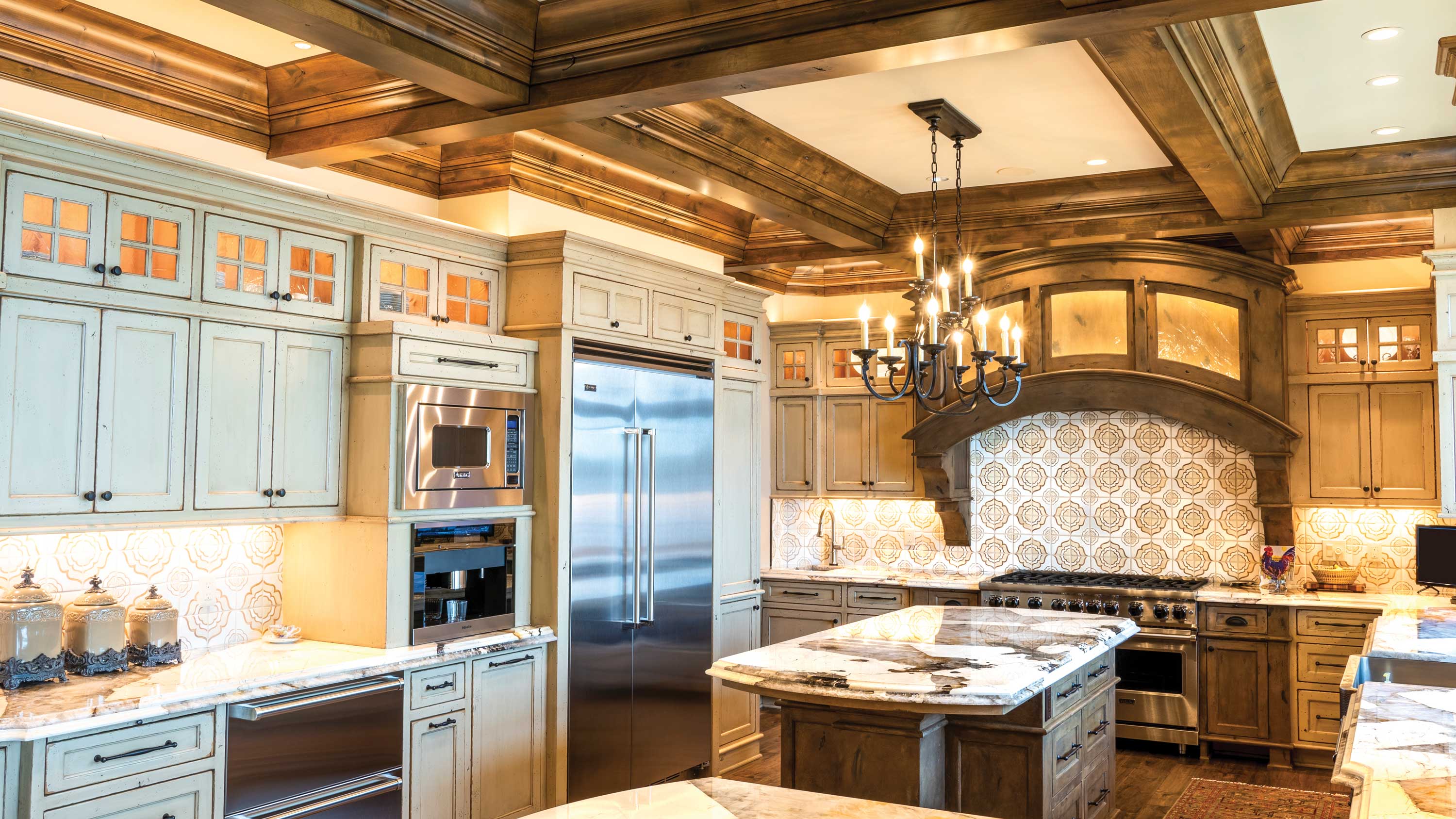 blue cabinets in a kitchen with sonance hidden audio video technology