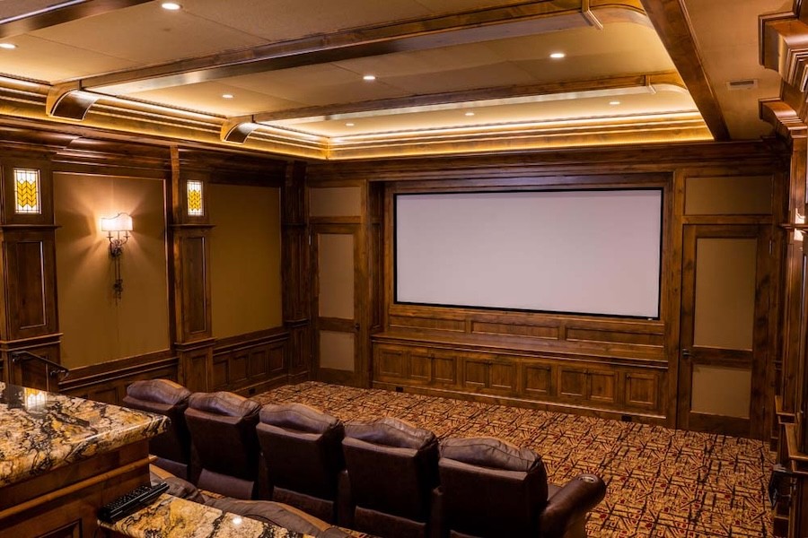 A home theater with brown luxury seating.